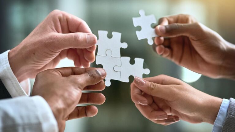 Hands building a jigsaw in the air - representation of API